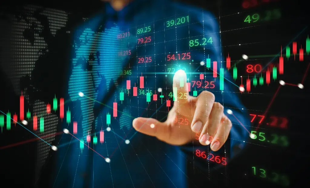  Sylwetka mężczyzny w tle z ręką skierowaną na cyfrowo wygenerowane wykresy giełdowe